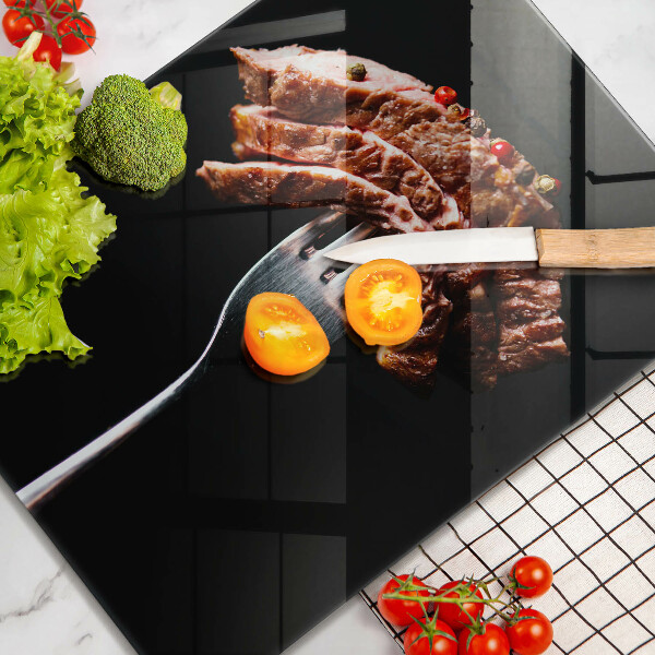 Chopping board glass Meat on a fork