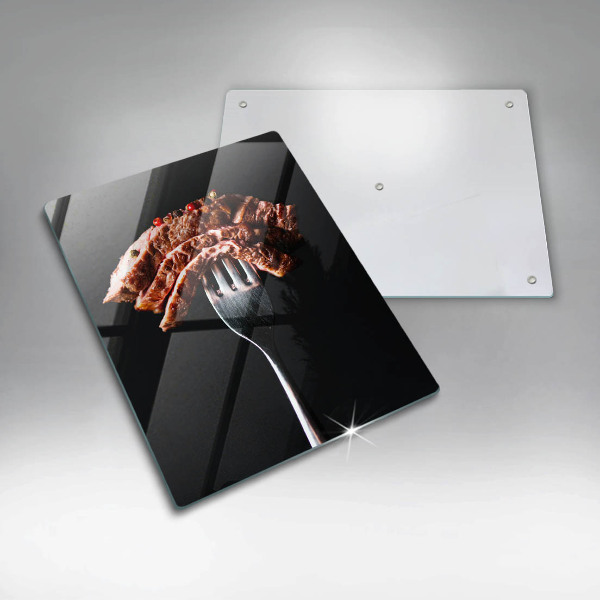 Chopping board glass Meat on a fork
