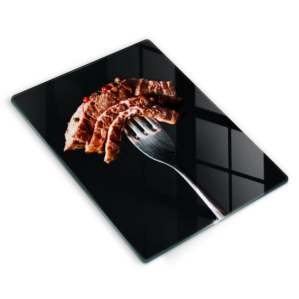 Chopping board glass Meat on a fork
