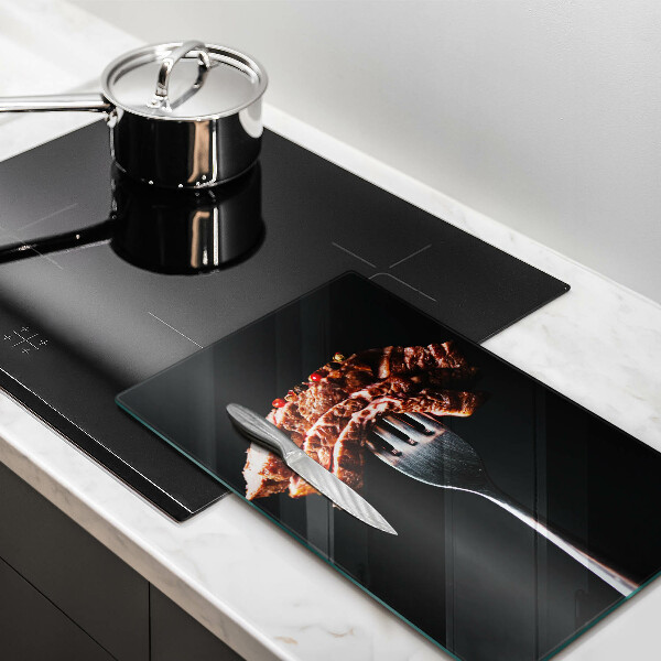 Chopping board glass Meat on a fork