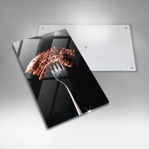 Chopping board glass Meat on a fork