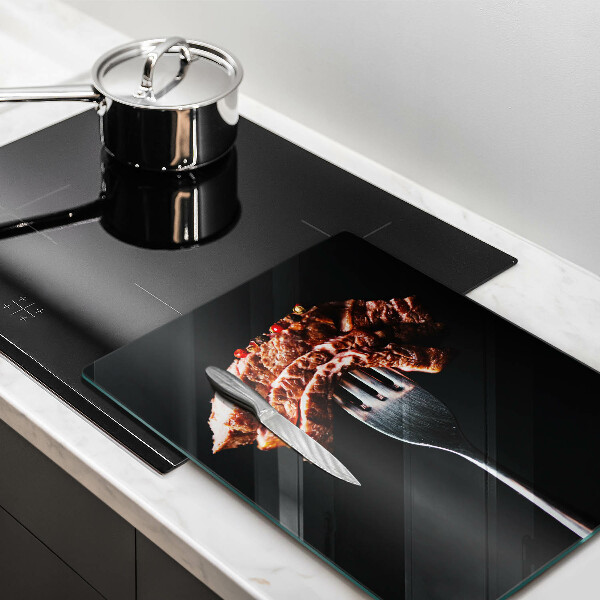 Chopping board glass Meat on a fork