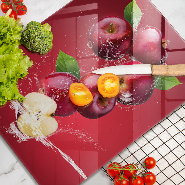 Chopping board glass Juicy apples in the water