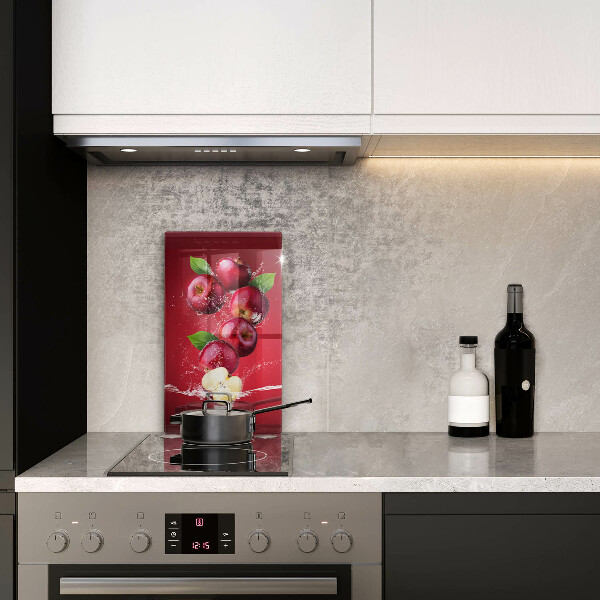 Chopping board glass Juicy apples in the water