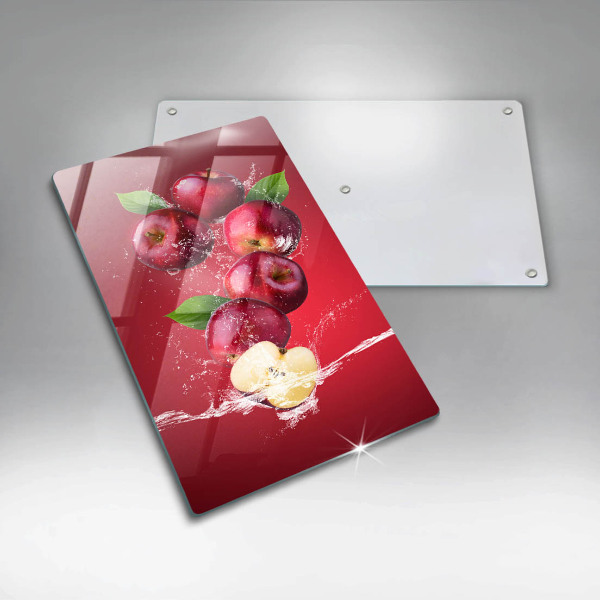 Chopping board glass Juicy apples in the water