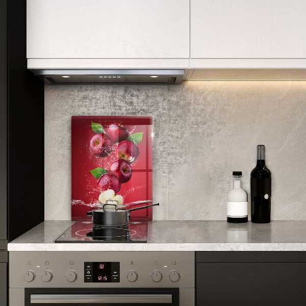 Chopping board glass Juicy apples in the water