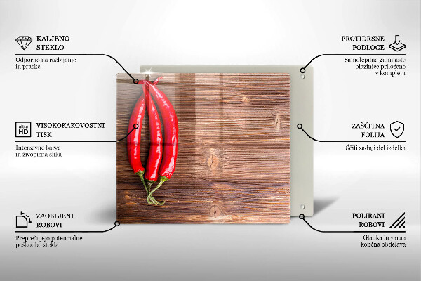 Chopping board glass Chili peppers on wood