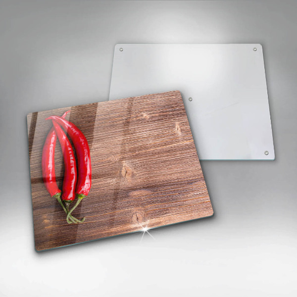Chopping board glass Chili peppers on wood