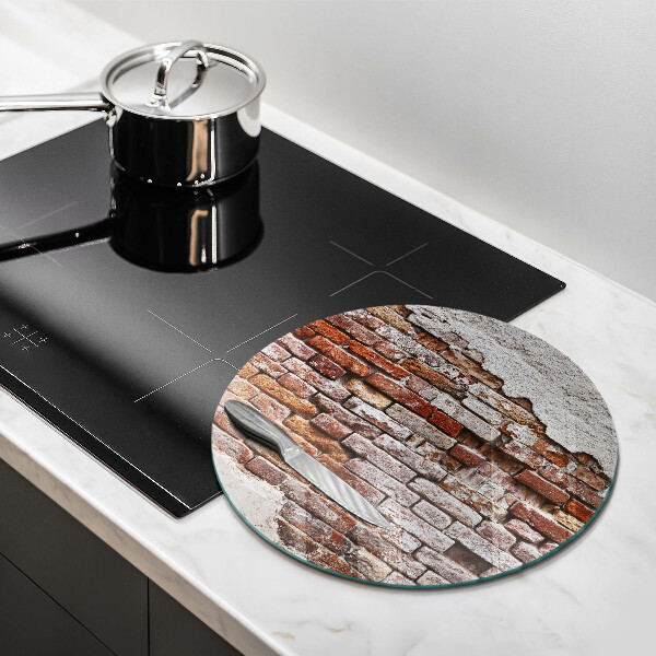 Chopping board glass Old wall of brick and concrete