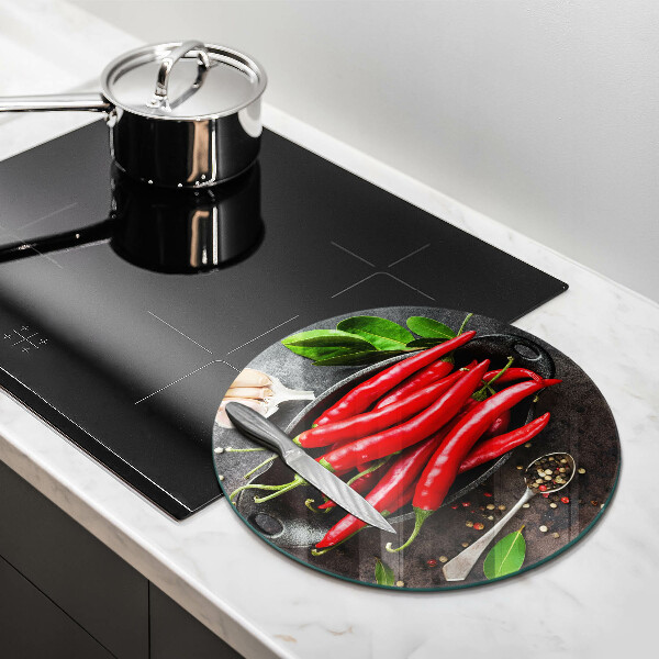 Chopping board glass Red chili peppers