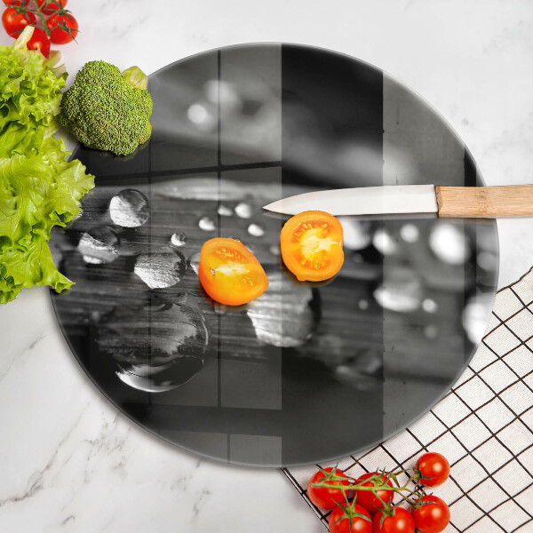 Chopping board glass Drops of dew on the leaves