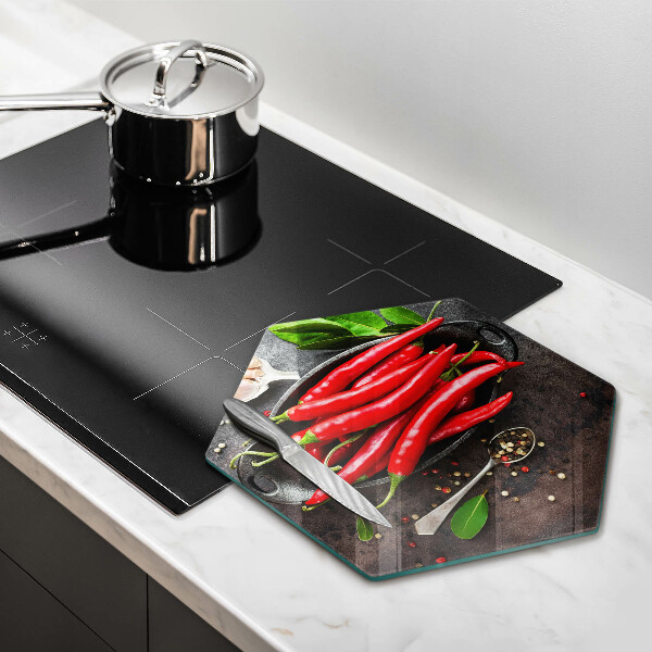 Chopping board glass Red chili peppers
