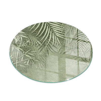 Round glass hearths for wood burners Tropical leaves in the background