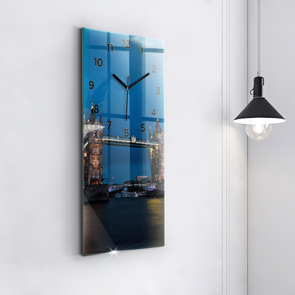 Vertical wall clock Tower Bridge London at night