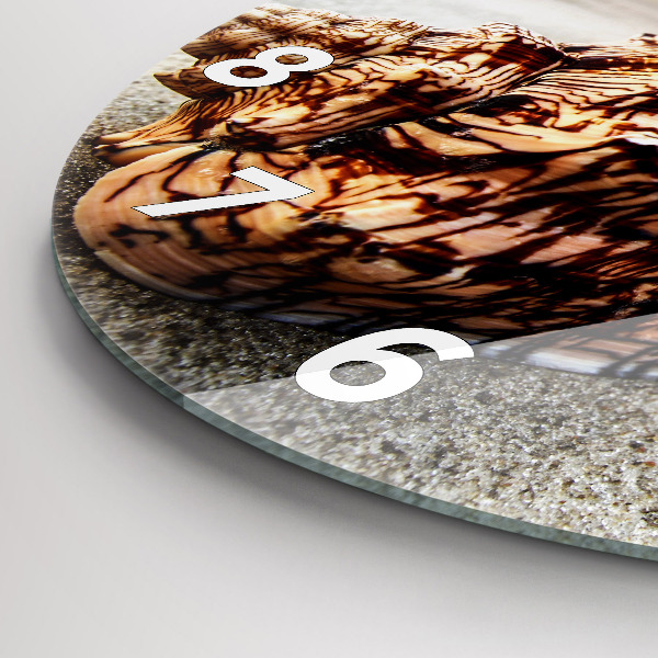 Round glass wall clock A shell on the beach