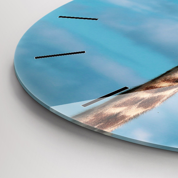 Round glass wall clock Giraffe head against the sky