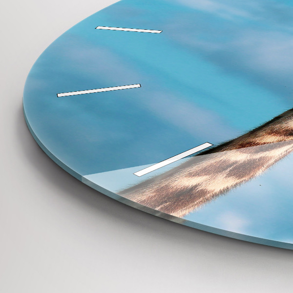 Round glass wall clock Giraffe head against the sky