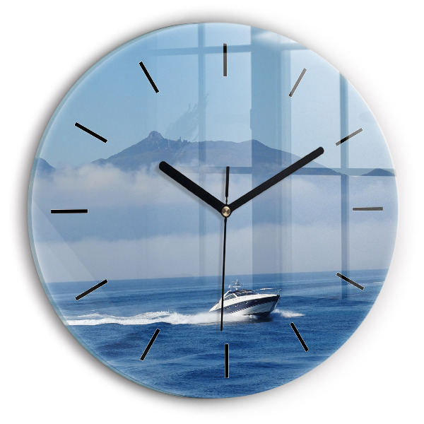 Round glass wall clock A boat floating on the ocean