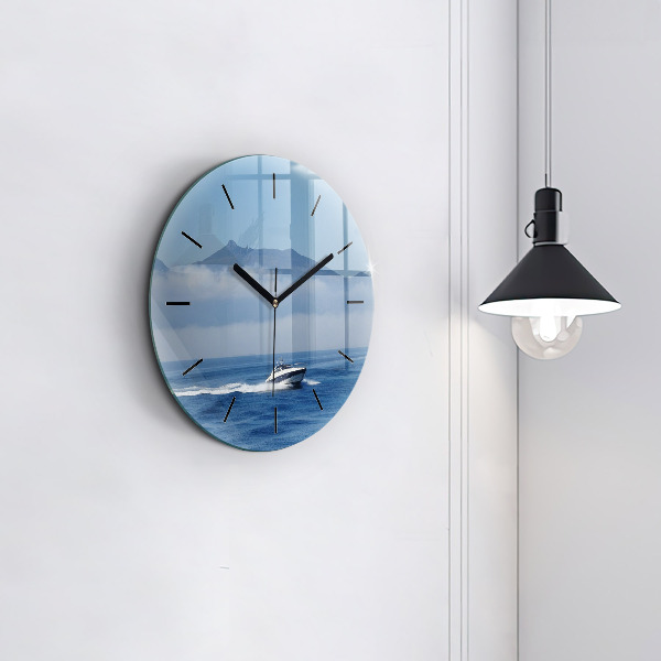 Round glass wall clock A boat floating on the ocean