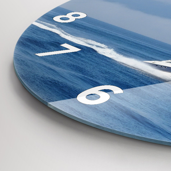 Round glass wall clock A boat floating on the ocean