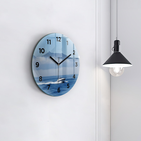Round glass wall clock A boat floating on the ocean