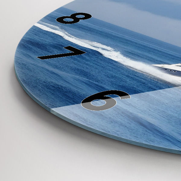 Round glass wall clock A boat floating on the ocean