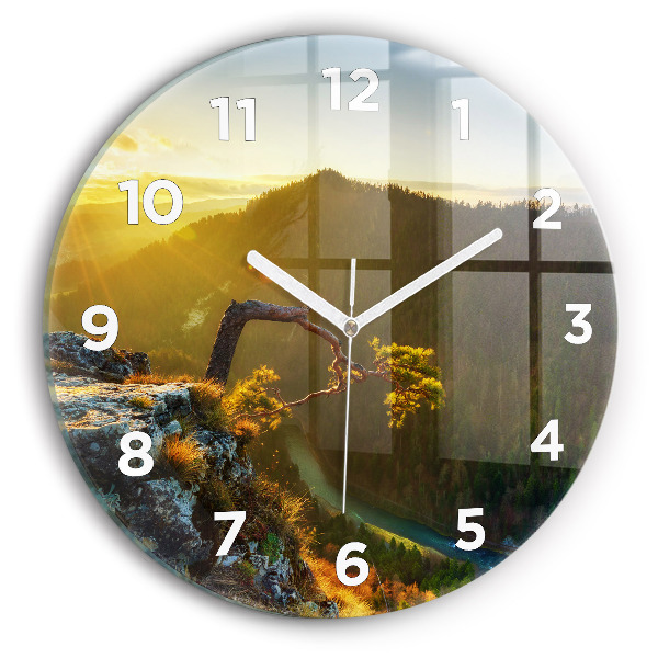 Round glass wall clock Sunset over the mountains