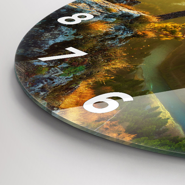 Round glass wall clock Sunset over the mountains