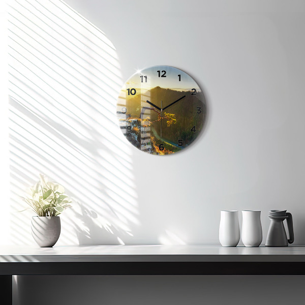Round glass wall clock Sunset over the mountains