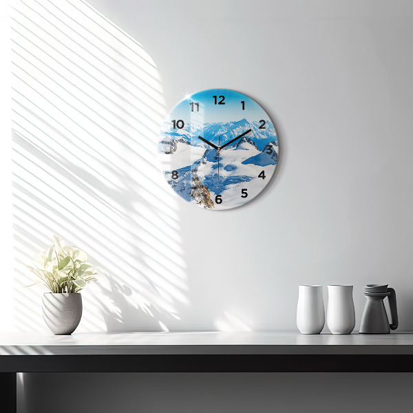 Round glass wall clock Skier in the Alps